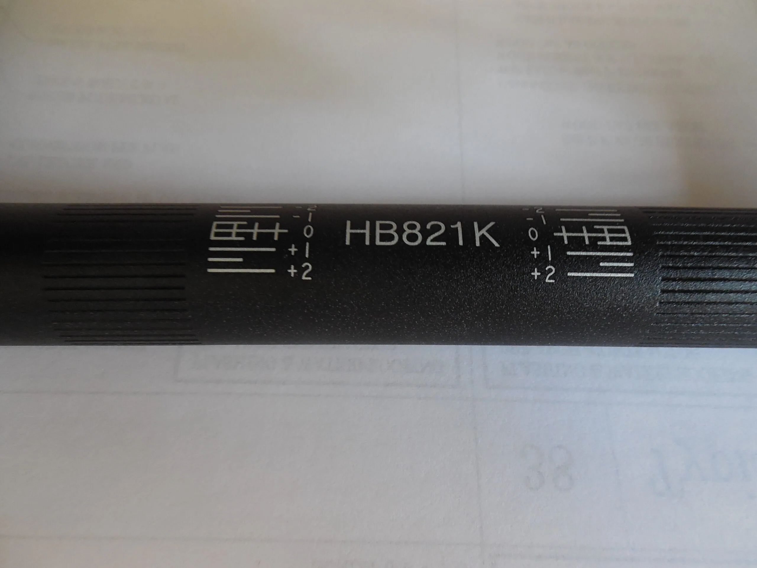 Black cable or connector labeled HB821K with numbered terminals and directional indicators on white background