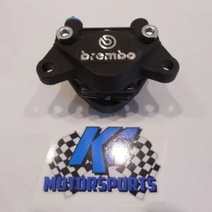 Black Brembo brake caliper with mounting bolts displayed above motorsports logo