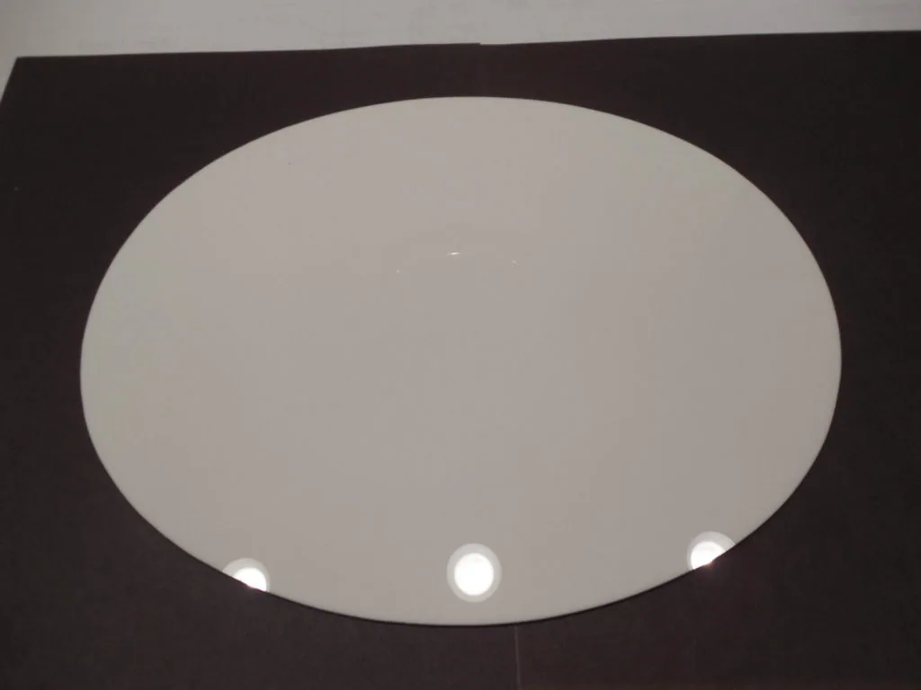 Oval recessed light fixture with frosted glass panel and three small white lights mounted in black ceiling frame