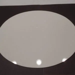Oval recessed light fixture with frosted glass panel and three small white lights mounted in black ceiling frame