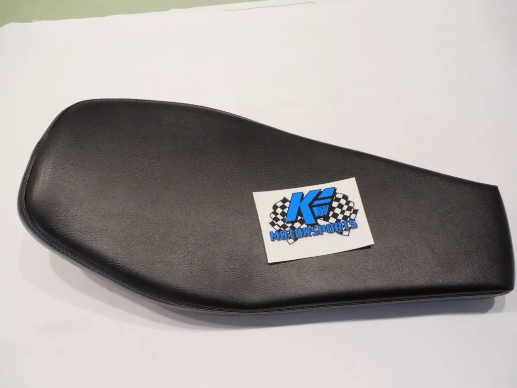 Black motorcycle seat with checkered racing logo sticker