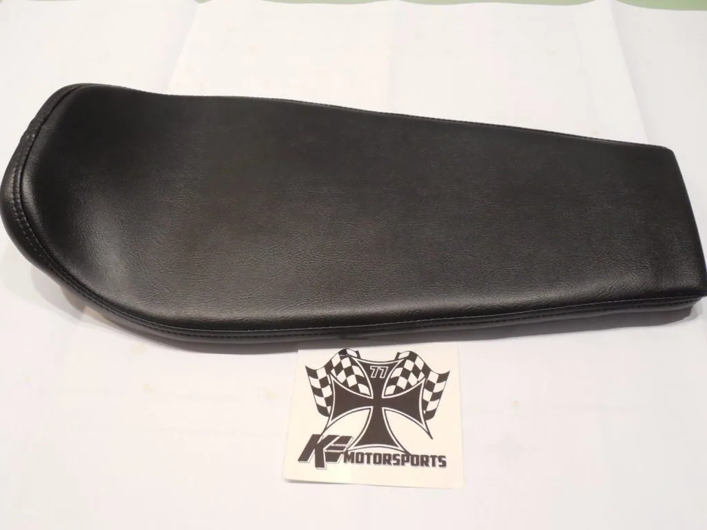 Black leather zippered case or pouch on white surface with motorsports logo