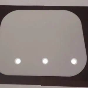 Gray panel with rounded corners mounted in dark brown frame featuring three white circular indicator lights in a horizontal row