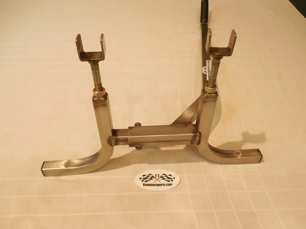 Brass fireplace log holder with two tall fork-shaped supports and wide curved feet