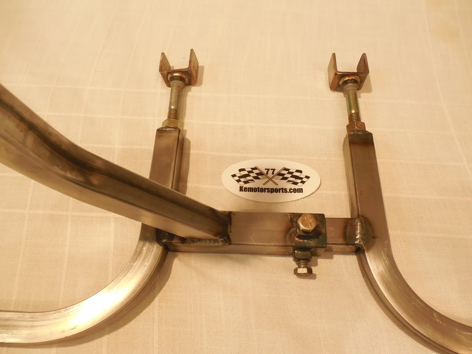 Bronze engine stand with curved support legs and adjustable mounting brackets