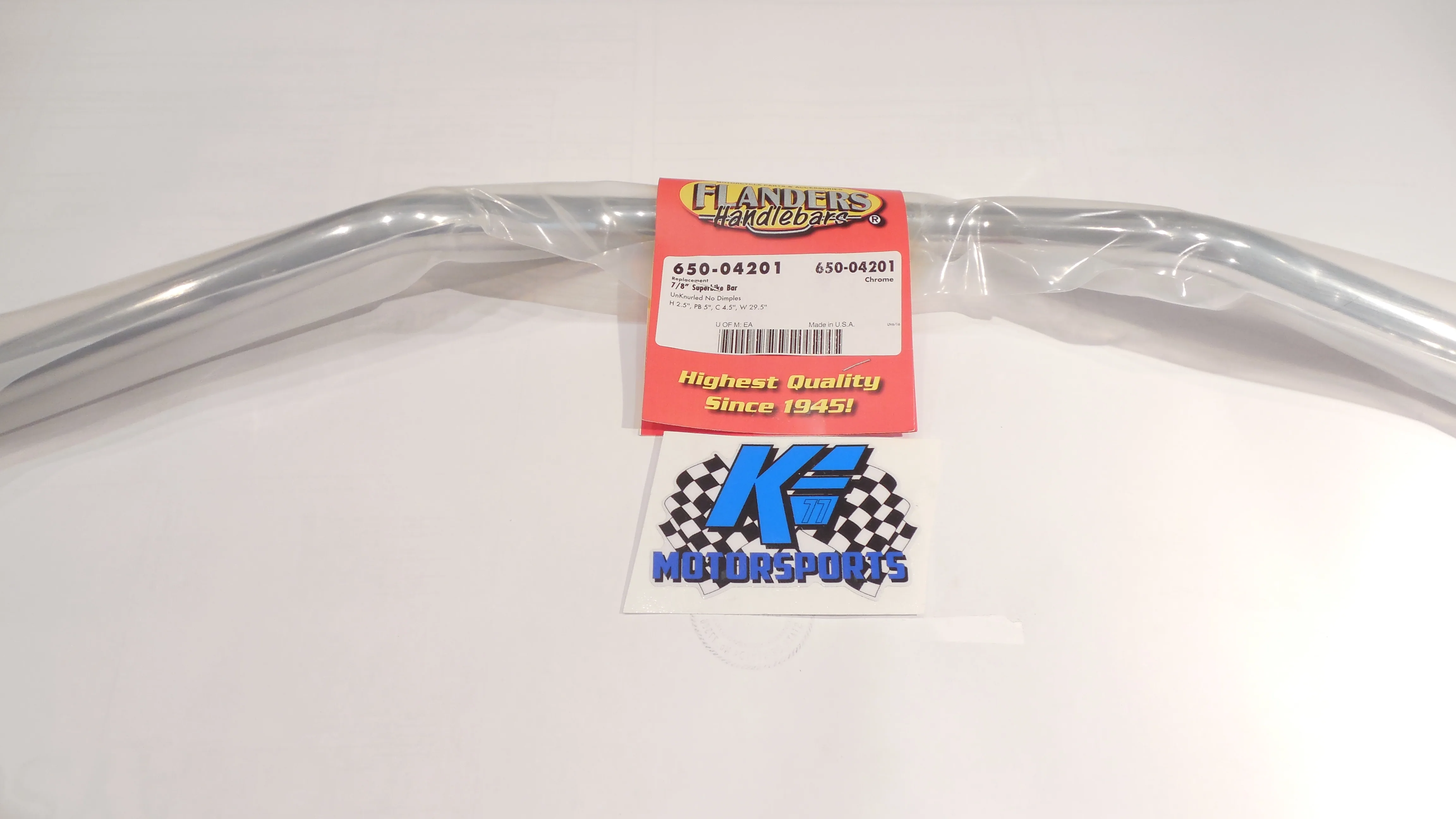 Aluminum motorcycle handlebars with red product label and motorsports branding tags on white background