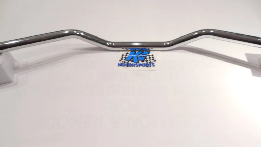 Polished chrome motorcycle handlebar with blue and checkered logo emblem in center