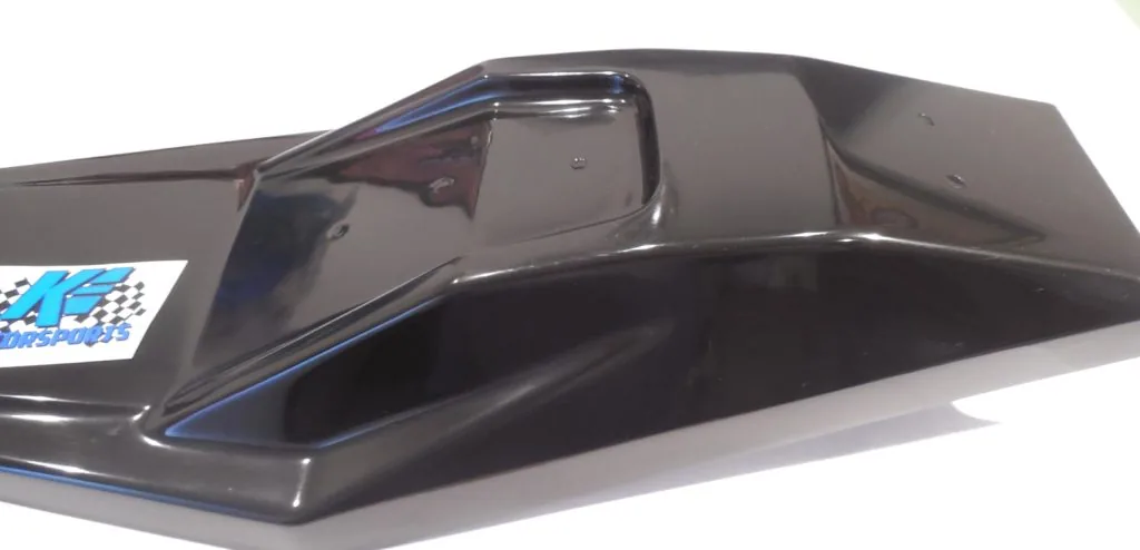 Black RC car body shell with blue racing stripes and checkered flag decal