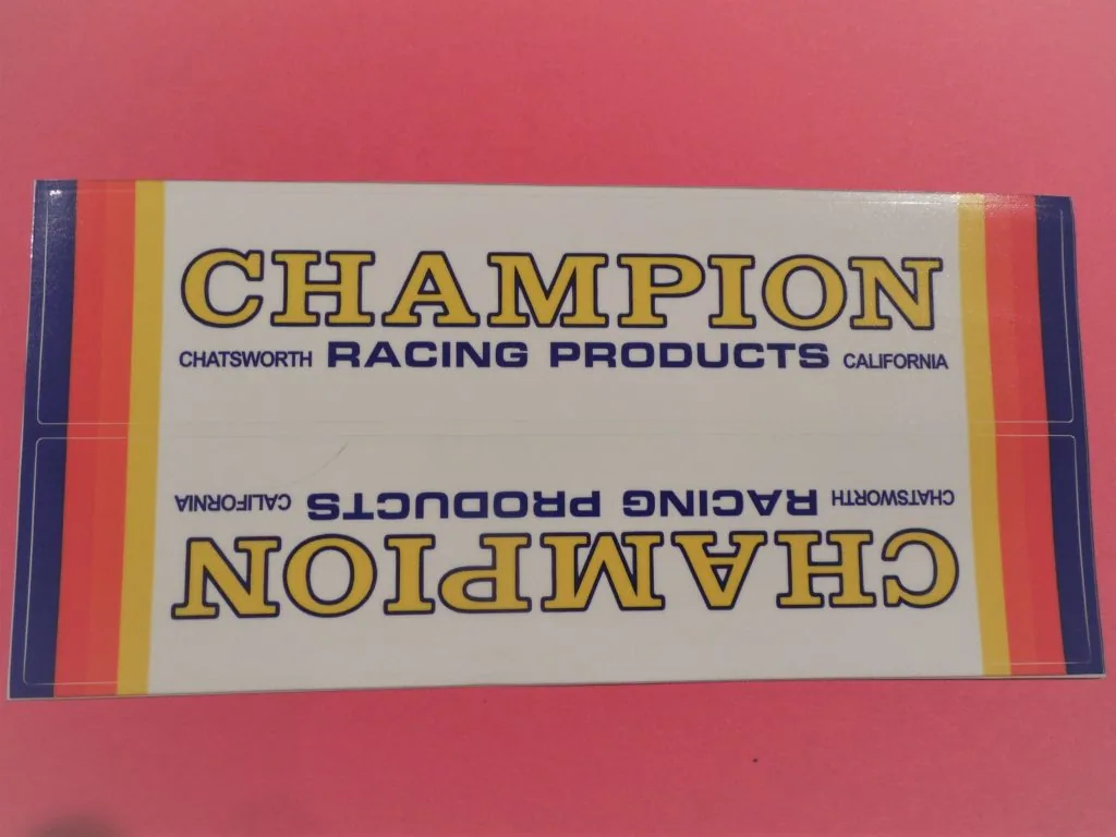 Vintage Champion Racing Products label from Chatsworth, California with red, yellow, and blue striped border