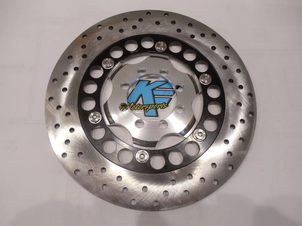 Perforated metal brake disc with black center ring and blue K-branded hub cap