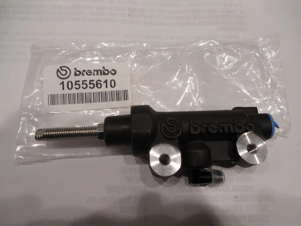 Brembo brake master cylinder part number 10555610 with metal adjustment screws in clear plastic packaging