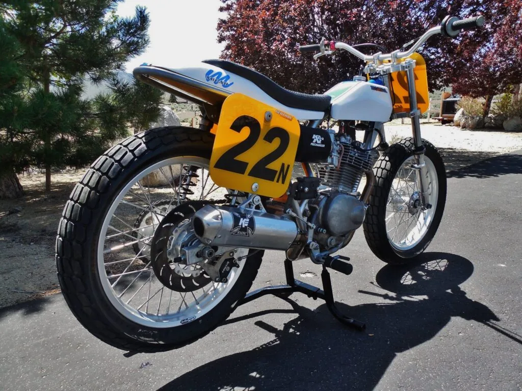 The number 22 flat tracker from the front three-quarter, chrome bars and spoked wheels