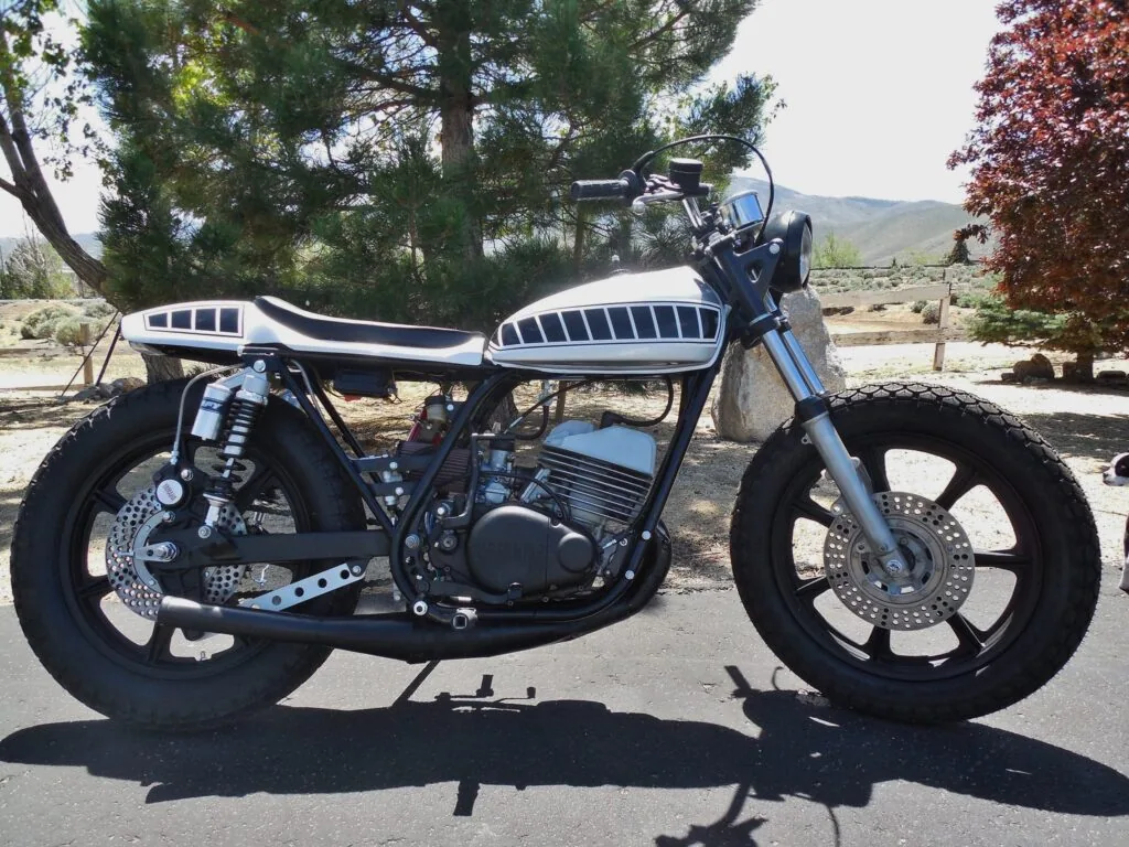 White café racer style bike with a black and white seat