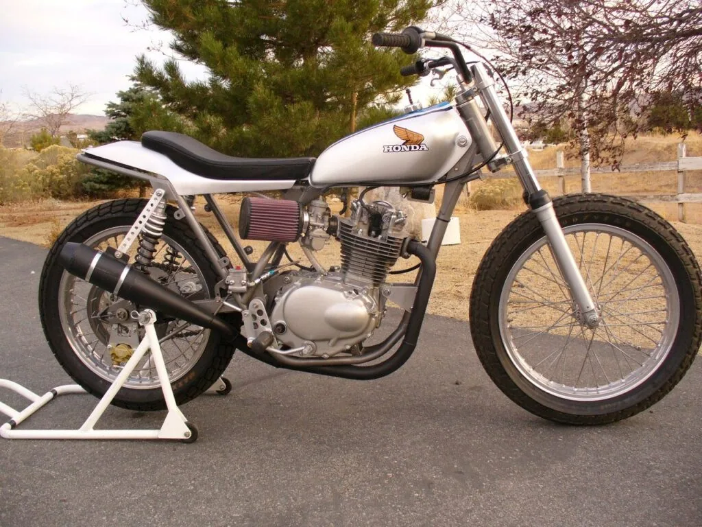Silver street tracker with a white tank on a work stand